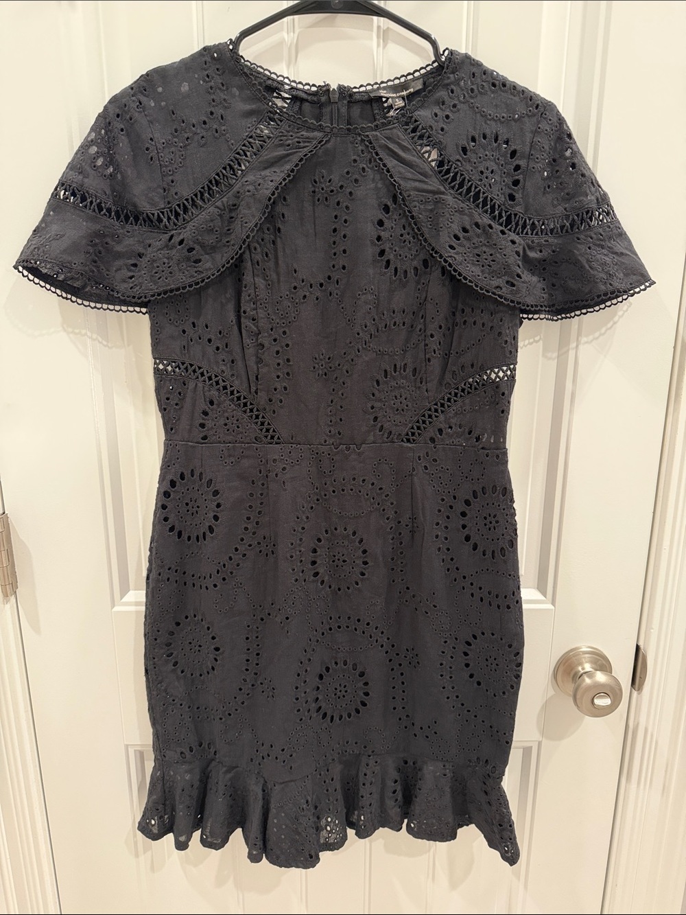 the clothing company Black Eyelet Ruffle Mini Dress